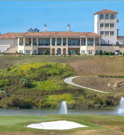 The Adena clubhouse overlooking the golf course, pond fountains in the foreground.