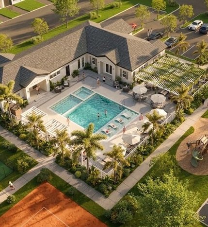 Aerial view of homes surrounding an outdoor swimming pool at Aurora Oaks.