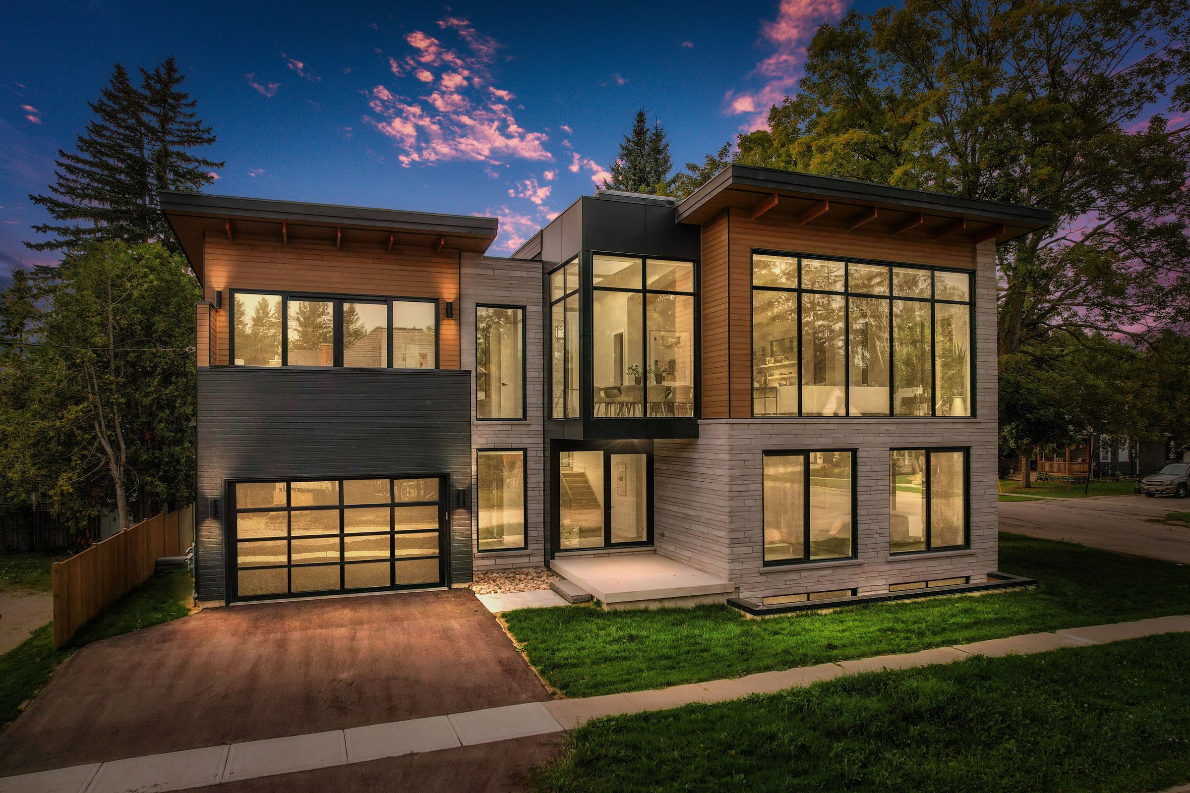 41 Alice Street at twilight, with warm interior light illuminating the front windows and glazed garage door.