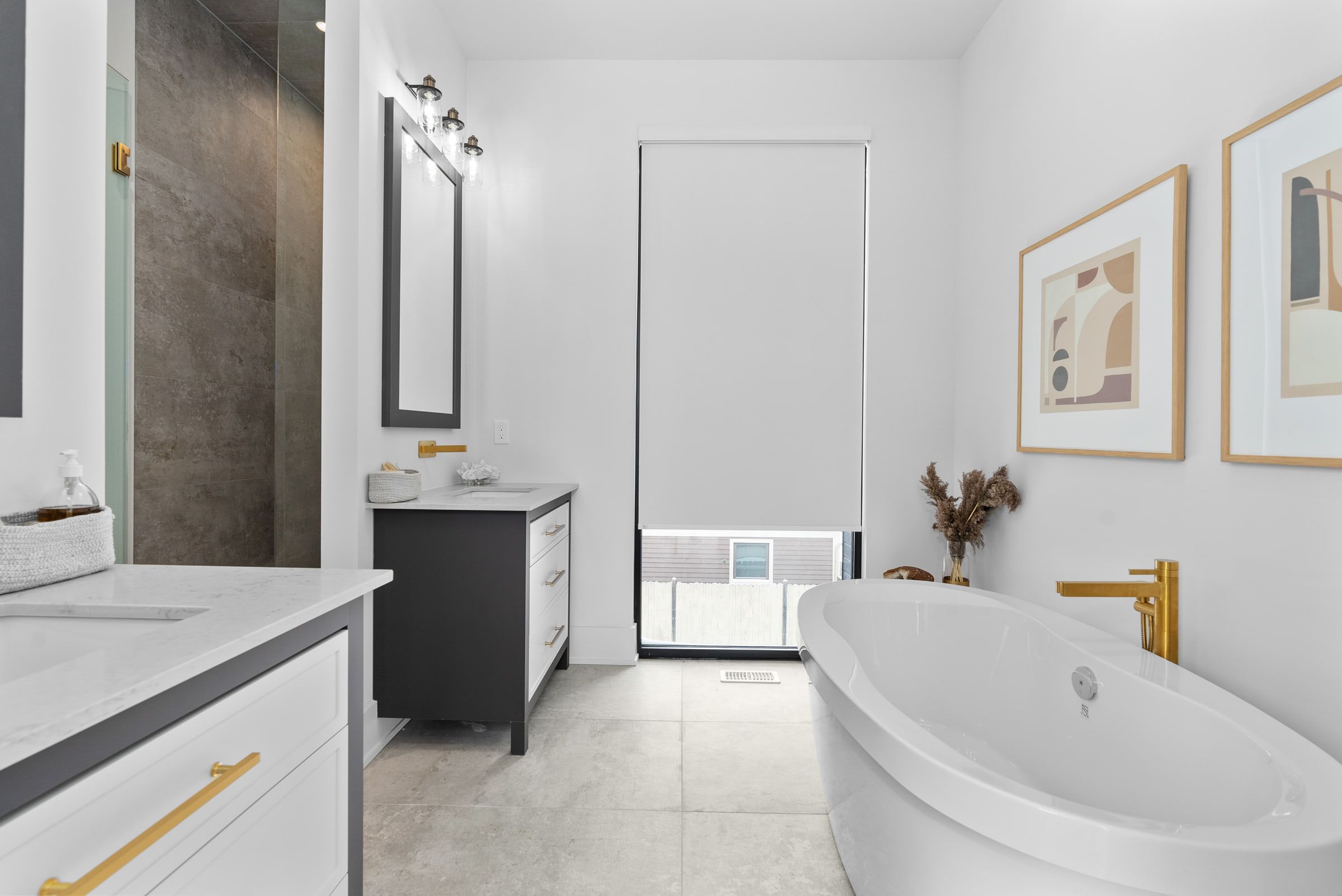 Freestanding bathtub beside the double vanity in the ensuite.