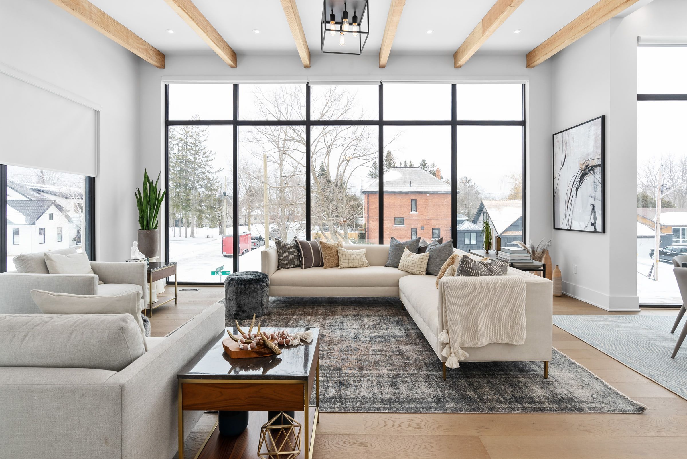 Living room with a linear fireplace and a wall of tall windows.