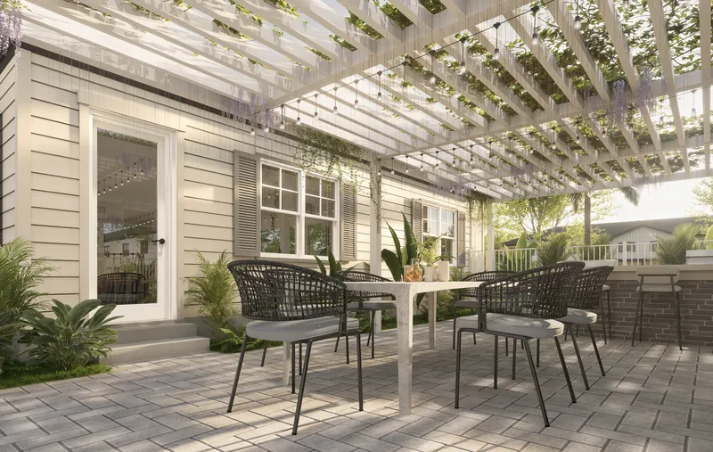 Shaded outdoor lounge beneath a white pergola.